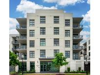 The Gadsden multi-story building featuring a light brick facade, balconies, and manicured landscaping at 5 Gadsdenboro St # 204, Charleston, SC 29401
