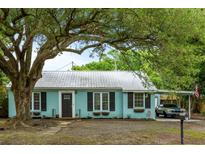 Charming home featuring a metal roof, updated windows, and a welcoming covered parking area at 532 Sunset Dr, Charleston, SC 29407