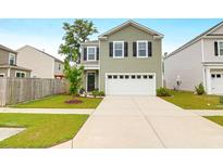 Charming two-story home featuring a two-car garage and well-manicured front lawn at 725 Pepperbush St, Charleston, SC 29414