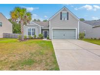 Charming single-Gathering home with manicured lawn, two car garage, and lush palm tree in desirable neighborhood at 7690 High Maple Cir, North Charleston, SC 29418