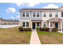 Charming two-story townhome with manicured lawn and inviting walkway to a dark blue front door at 7780 Montview Rd, North Charleston, SC 29418