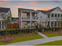 Charming two-story home with a welcoming front porch and second story balcony at 886 Clay Field Trl, Summerville, SC 29485