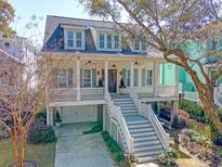 Charming home featuring a welcoming porch, multiple dormers and ground floor garage at 1141 Hills Plantation Dr, Charleston, SC 29412