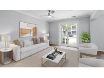 Bright living room with neutral tones, stylish furnishings, and sliding glass doors to outdoor area at 130 River Landing Dr # 4102, Charleston, SC 29492