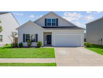 Charming two-story home with a well-maintained lawn, a garage, and a classic architectural style at 134 Percheron Dr, Summerville, SC 29486