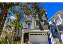 Charming two-story home with a garage and lush landscaping at 25 Ocean Point Dr, Isle of Palms, SC 29451