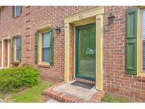 Brick townhouse exterior with green shutters and door at number 10 at 302 Springview Ln # 10, Summerville, SC 29485