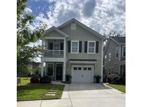 Charming two-story home with a front porch, balcony, manicured lawn, and a two-car garage at 315 Grouse Park, Charleston, SC 29414