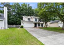 Charming two-story home featuring a well-maintained lawn, attached garage, and welcoming curb appeal at 332 Damascus Dr, Summerville, SC 29483