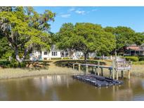Waterfront home with mature trees, dock, and floating dock providing access to the water at 3948 Gift Blvd, Johns Island, SC 29455