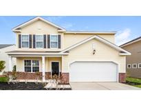 Charming two-story home with a black door, shutters and an attached two-car garage at 4021 Sanderson Ln, Summerville, SC 29483