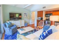 Comfortable living room featuring a large TV, blue accents, and an open floor plan at 4233 Mariners Watch, Johns Island, SC 29455