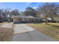 Charming brick home with an attached carport and well-maintained front yard at 4765 S Constellation Dr, North Charleston, SC 29418