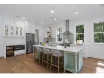 Bright kitchen features a large island, stainless steel appliances, and hardwood flooring at 5105 St George Ln, Hollywood, SC 29449
