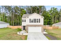 Charming two-story home with a two-car garage, brick accents, and manicured front lawn at 514 Shady Maple St, Moncks Corner, SC 29461