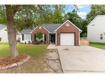 Charming brick home with attached garage and well-manicured lawn at 5332 Copley Cir, Summerville, SC 29485