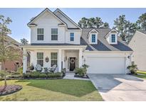 Charming two-story white home with landscaped front yard and inviting front porch at 612 S Pointe Blvd, Summerville, SC 29483