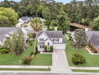 Charming two-story home featuring a well-manicured lawn and attached garage, perfect for suburban living at 613 Antebellum Ln, Mount Pleasant, SC 29464