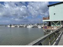 Scenic view of the marina with boats docked, offering waterfront living and recreational opportunities at 67 W 10Th St # E-3, Folly Beach, SC 29439