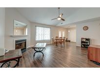 Inviting living room featuring a fireplace, wood floors, and an open floorplan perfect for entertaining at 7955 Timbercreek Ln # 1807, North Charleston, SC 29418