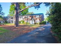 Townhomes with tree-lined street, brick facade, and a paved driveway at 926 Lansing Dr # 926-G, Mount Pleasant, SC 29464