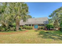 Charming single-story brick home with a lush, landscaped front yard and inviting blue double doors at 968 Cummings Cir, Mount Pleasant, SC 29464