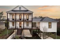 Stunning 3 story home with a metal roof, grand staircases, and beautiful decks and patios at 000 Remington Trl, Johns Island, SC 29455