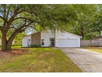 Charming single-Gathering home with white siding, stone accents, and a spacious two-car garage at 1024 Willowood Ave, Goose Creek, SC 29445