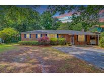 Charming brick home with mature trees and a well-maintained front yard at 106 Newington Rd, Summerville, SC 29485