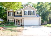 Charming two-story home with a manicured lawn, a two-car garage, and classic architectural details at 109 Holly St, Summerville, SC 29485