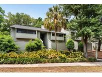 Inviting condo with lush landscaping, palm tree and charming two-story facade, perfect for low-maintenance living at 1142 Village Creek Ln # 4, Mount Pleasant, SC 29464