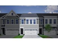 Charming townhome featuring gray siding, a two-car garage, and a well-maintained lawn with a young tree at 122 Brown Swiss Circle, Summerville, SC 29483