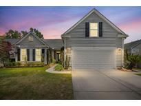 Charming home with a two-car garage, manicured lawn, and inviting front facade at 1708 Waterbrook Dr, Charleston, SC 29414