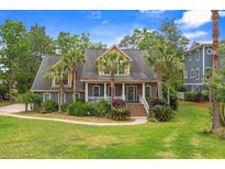 Charming home with palm trees, well-maintained lawn, and inviting front porch at 1721 Bowline Dr, Mount Pleasant, SC 29466