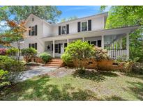 Charming two-story home featuring a welcoming front porch with brick steps and landscaped yard at 197 High Grove Rd, Summerville, SC 29485