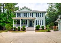 Charming two-story home with light-blue siding, white trim, and a welcoming front porch at 1976 Liberia Rd, Wadmalaw Island, SC 29487