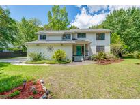Charming two-story home with a well-maintained lawn and a welcoming blue front door at 25 Fitzroy Dr, Charleston, SC 29414