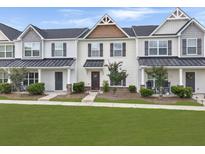 Charming townhouse featuring a covered entry, landscaped yard, and welcoming front door at 312 Silverdrop St, Goose Creek, SC 29445