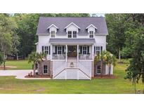 Charming two-story home with a welcoming porch and a beautifully landscaped front yard at 4205 Cobble Trot Way, Johns Island, SC 29455