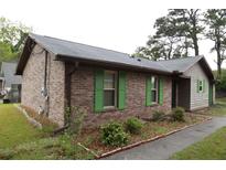 Charming brick home with green shutters and a well-maintained landscape at 814 Armsway St, Mount Pleasant, SC 29464