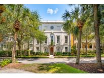Stately home exterior featuring an elegant facade, mature trees, and a meticulously landscaped lawn at N Blvd, Mount Pleasant, SC 29464