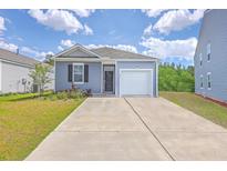 Charming single-Gathering home with a garage and a well-maintained lawn on a sunny day at 1003 Peridote Way, Ladson, SC 29456