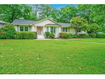 Charming home with a lush green lawn and well-manicured landscaping at 1035 Planters Curve, Mount Pleasant, SC 29464