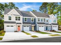 Charming townhomes featuring individual garages, colorful front doors, and eye-catching architectural details at 1050 Crescent Cove Ln, Summerville, SC 29483