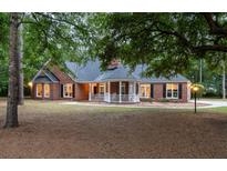 Charming brick home with a covered front porch and manicured lawn at 111 Coltsgate Ct, Summerville, SC 29485