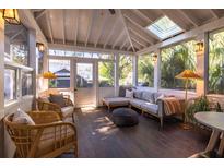 Inviting sunroom with vaulted ceilings, skylights, and cozy seating, perfect for relaxation and enjoying natural light at 1153 King St, Charleston, SC 29403