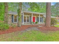 Charming brick home with a bright red front door and a cozy, inviting porch at 206 Jimbo Rd, Summerville, SC 29485