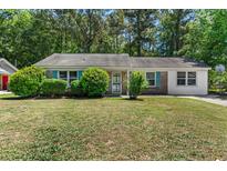 Charming single-story home features lush front yard and a mix of brick and siding exterior at 3249 Stonehaven Dr, North Charleston, SC 29420