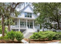 Charming two-story home featuring a welcoming front porch, white railings, and lush landscaping at 3305 Knot Aly, Johns Island, SC 29455