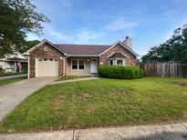 Charming brick home featuring a well-maintained lawn, attached garage, and beautiful landscaping at 4500 Winterwood Pl, Ladson, SC 29456